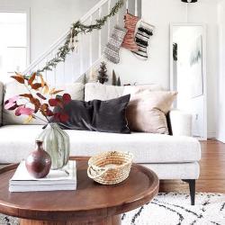 A wood grain coffee table is the perfect decorative contrast to this plush boho shag and chic puffy
